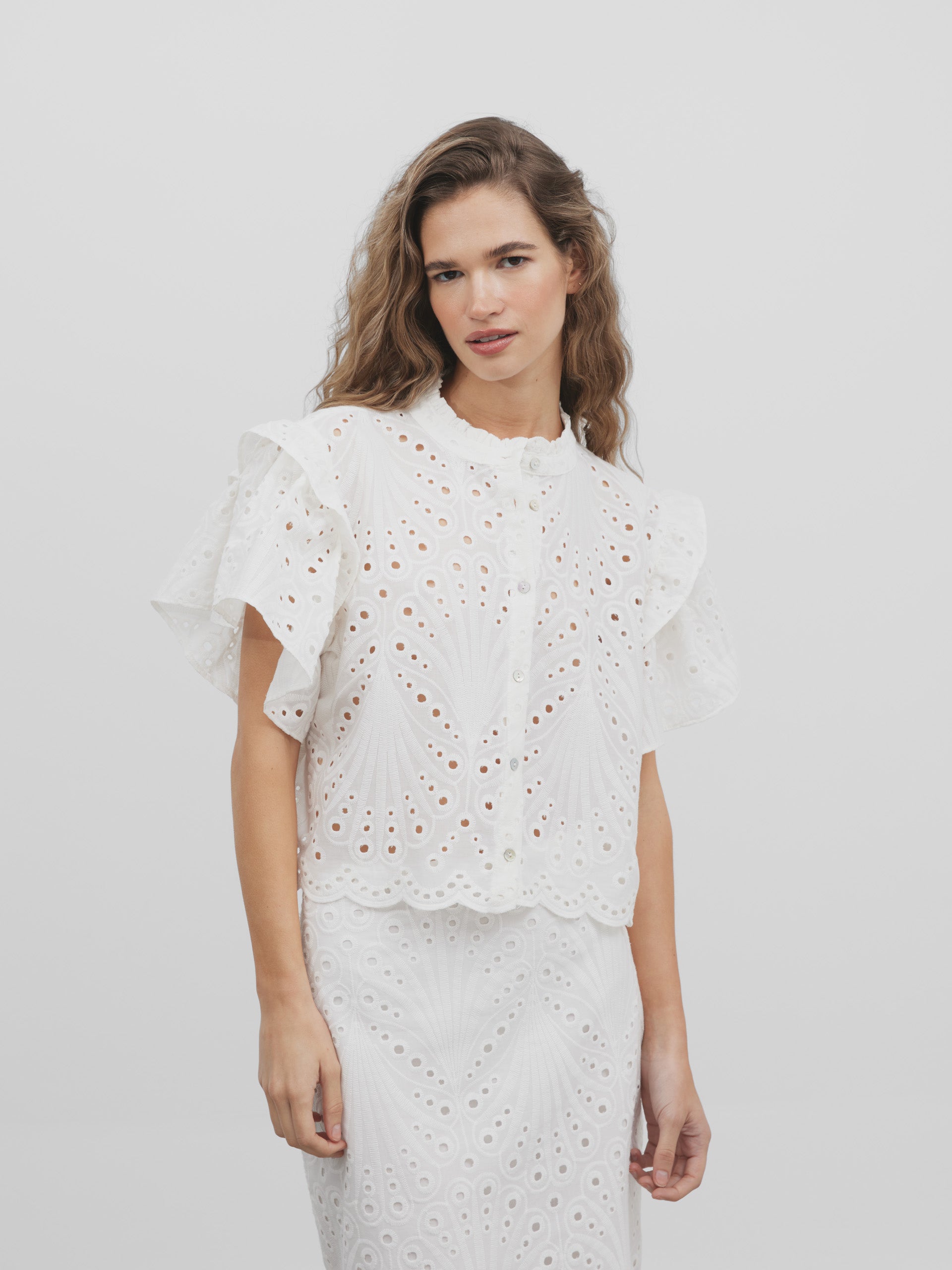 White embroidered ruffle blouse