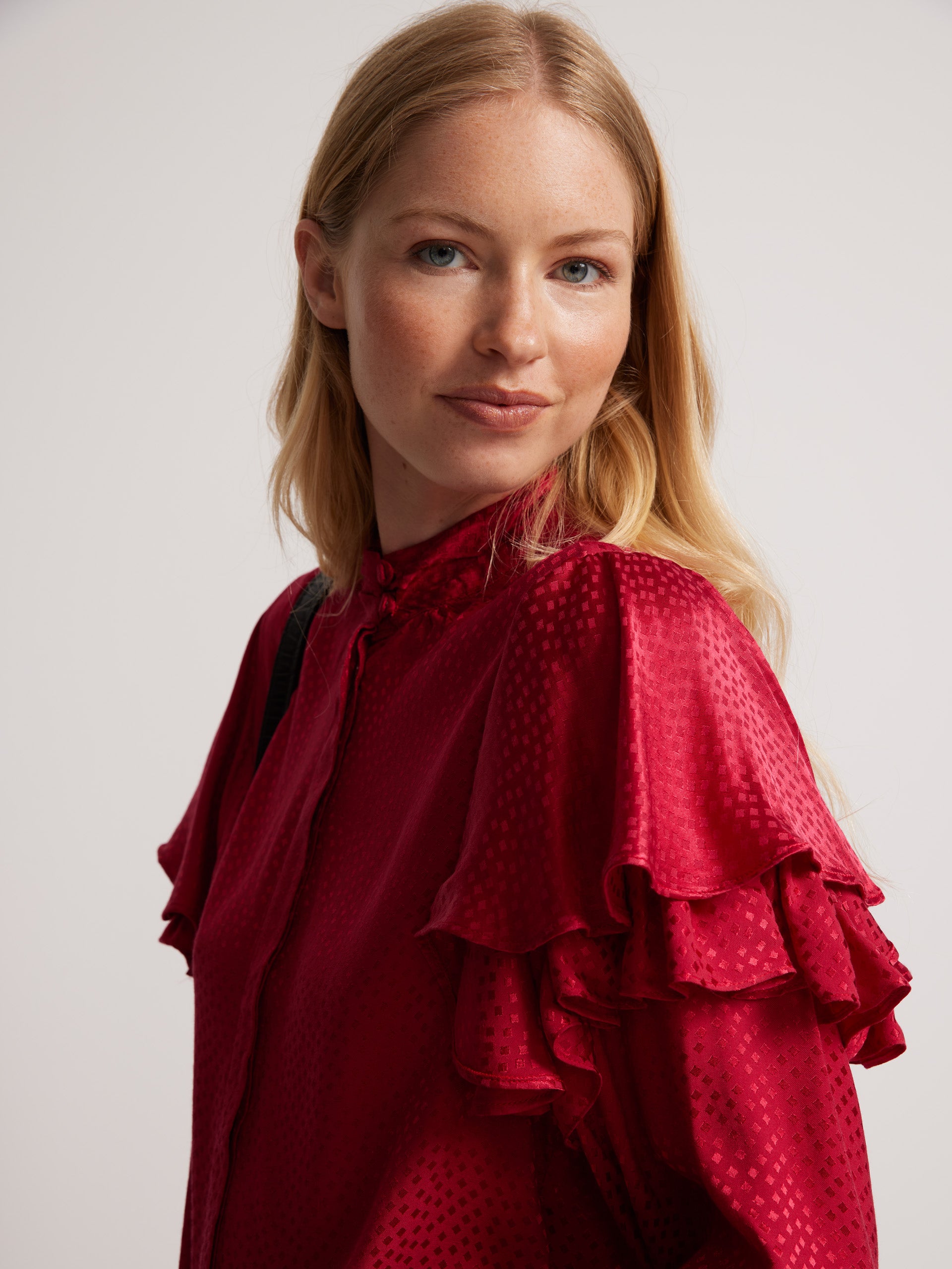 Red jacquard ruffle blouse